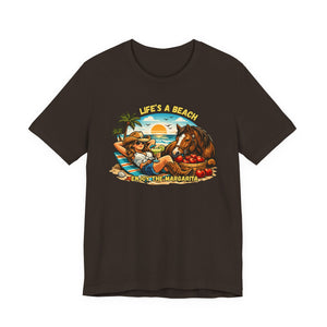 Life's A Beach Western Tee featuring a cowgirl, horse, and sunset design, perfect for casual beach wear.