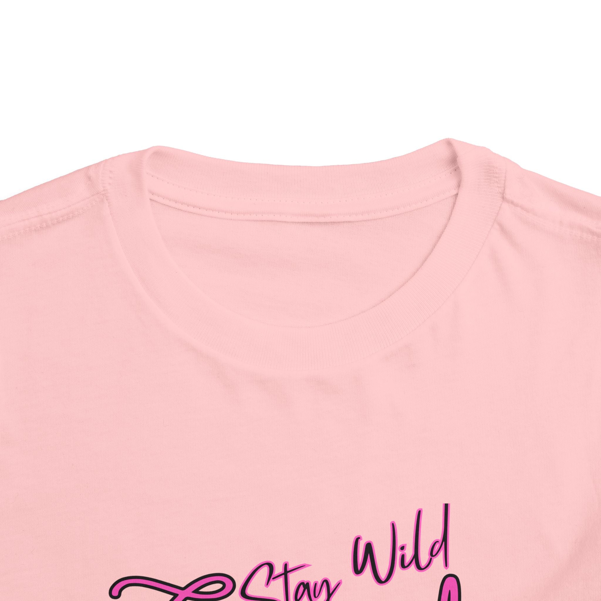 Toddler Cowgirl Tee featuring playful design that reads 'Stay Wild Cowgirl' on soft pink fabric.