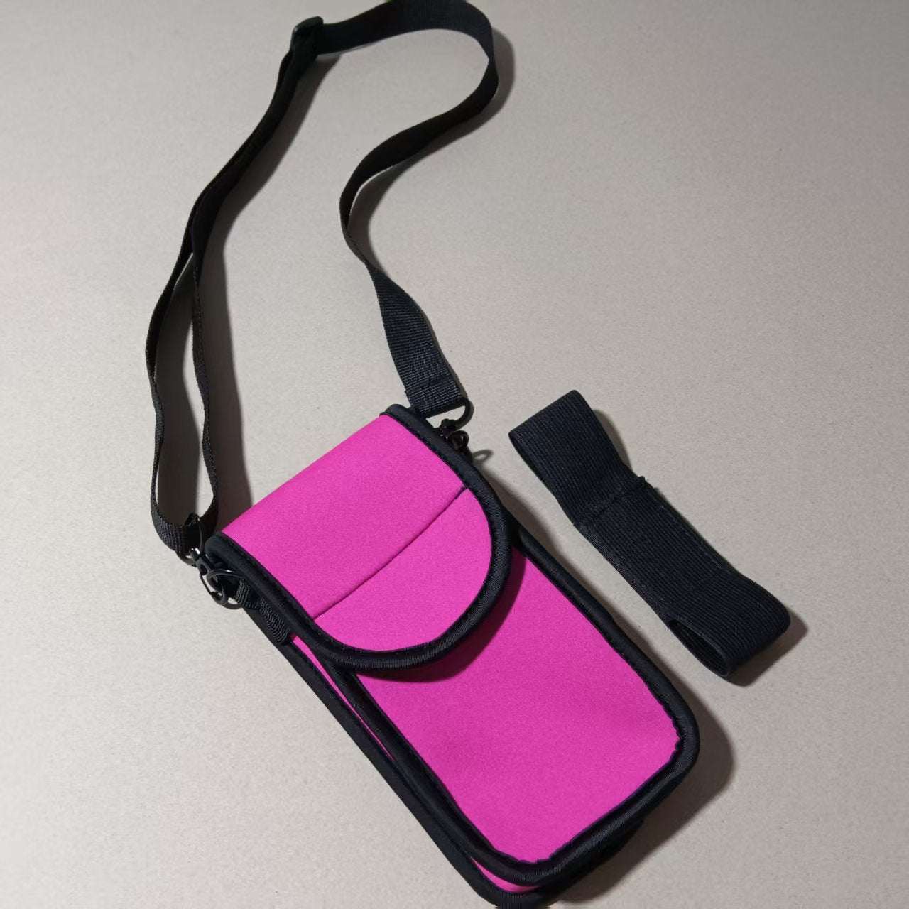 Cell Phone Holster in pink with adjustable strap, designed for securely holding phones while riding.