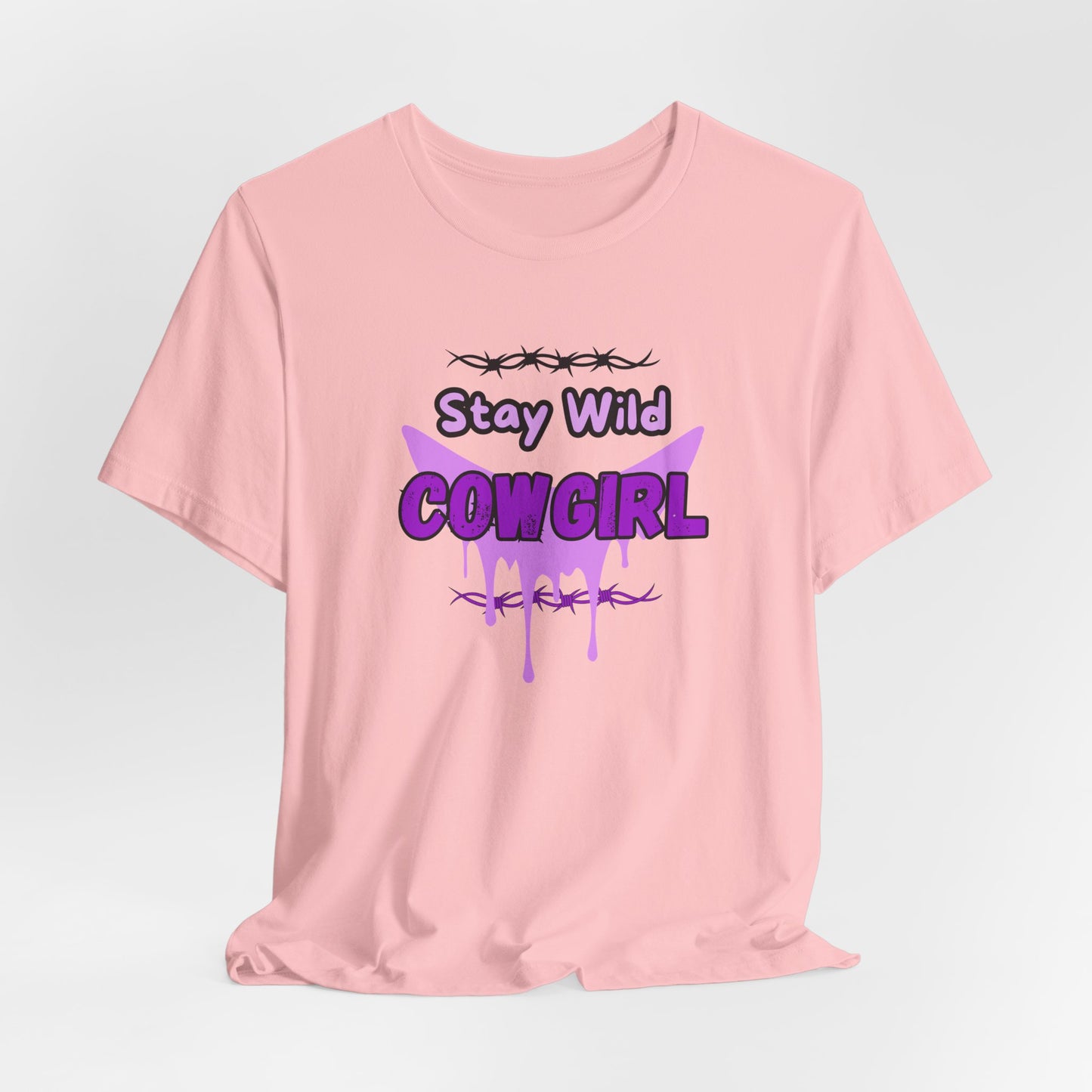 Cowgirl Western Tee featuring a bold purple graphic with barbed wire and the text "Stay Wild COWGIRL" on a pink background.