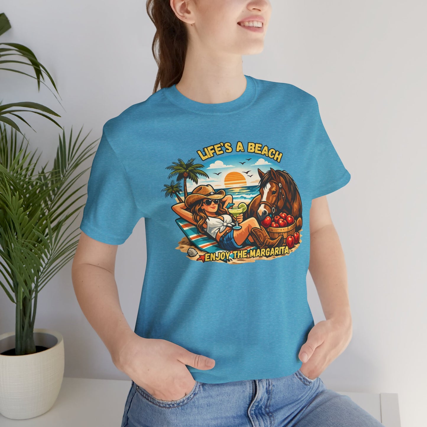 Life's A Beach Western Tee featuring a cowgirl relaxing with a horse and enjoying Margaritas on the beach.