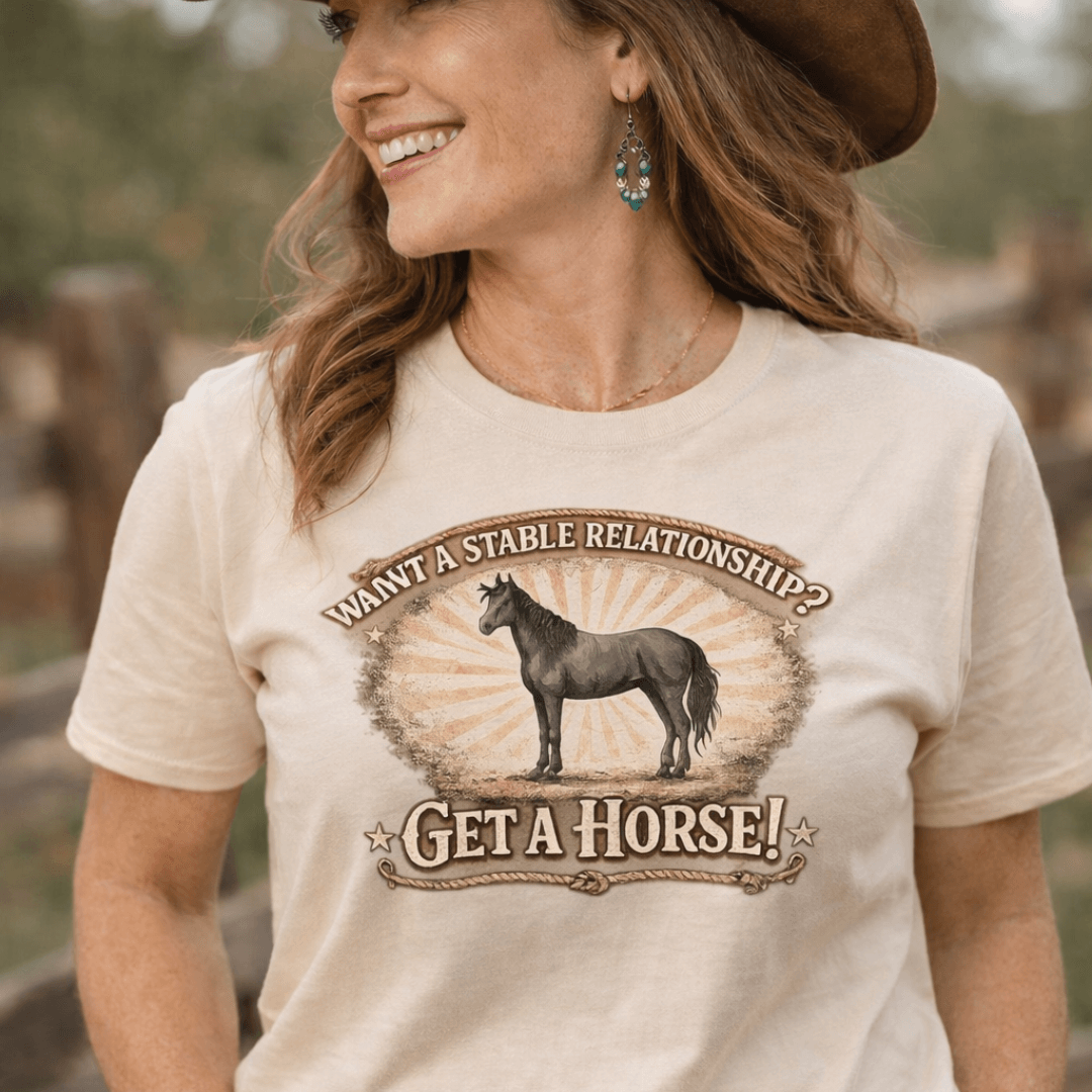 Woman wearing a 'Get A Horse' t-shirt with barnyard humor and vintage design outdoors.