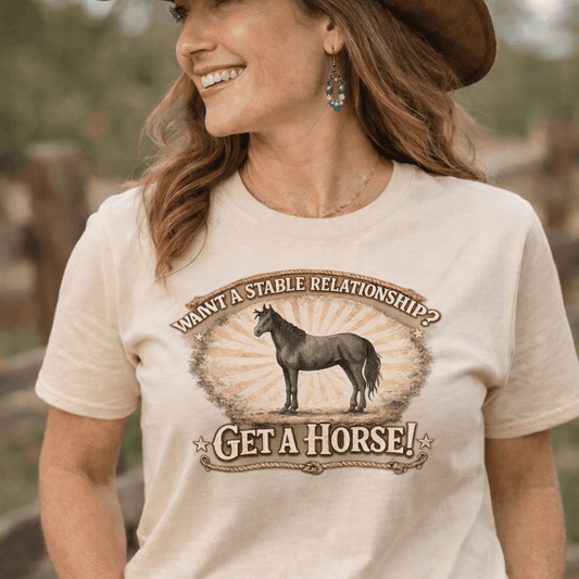 Woman wearing a 'Get A Horse' t-shirt with barnyard humor and vintage design outdoors.