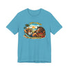 Life's A Beach Western Tee featuring a cowgirl, horse, and tropical scene on a blue shirt.