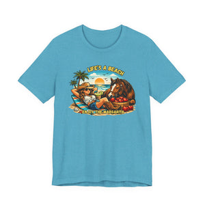 Life's A Beach Western Tee featuring a cowgirl, horse, and tropical scene on a blue shirt.