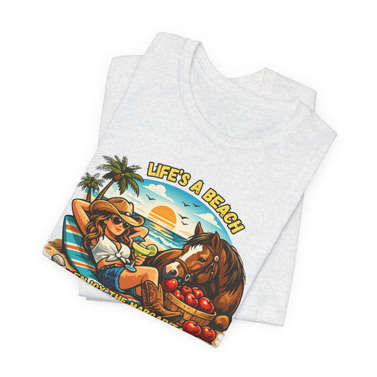 Life's A Beach Western Tee featuring a cowgirl enjoying a sunset with a horse and fruits, perfect for casual summer days.