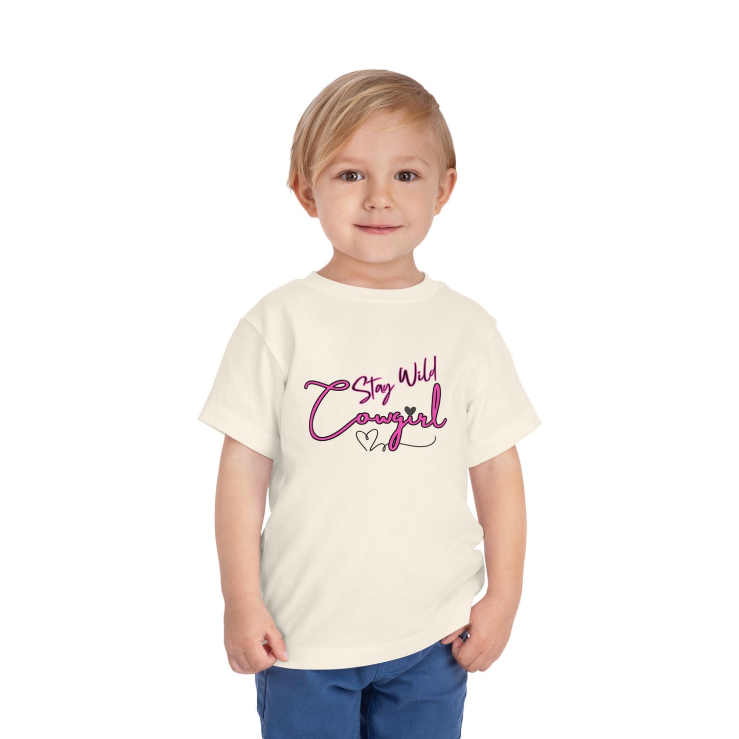 Toddler Cowgirl Tee featuring 'Stay Wild Cowgirl' design on a smiling child, perfect for playful adventures.