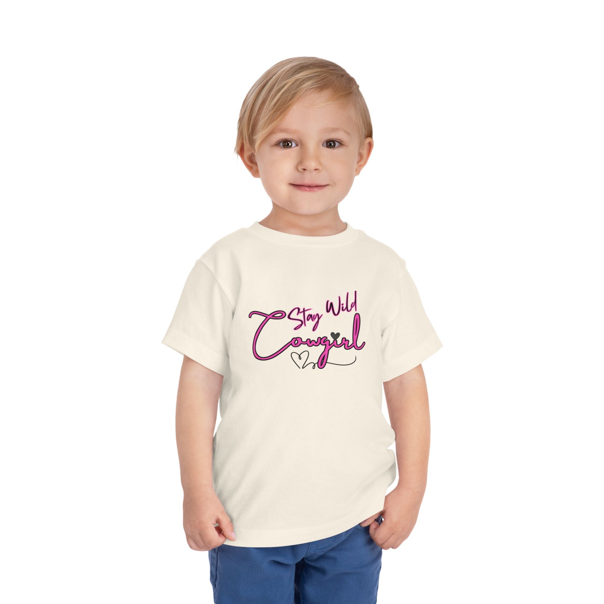 Toddler Cowgirl Tee featuring 'Stay Wild Cowgirl' design on a smiling child, perfect for playful adventures.