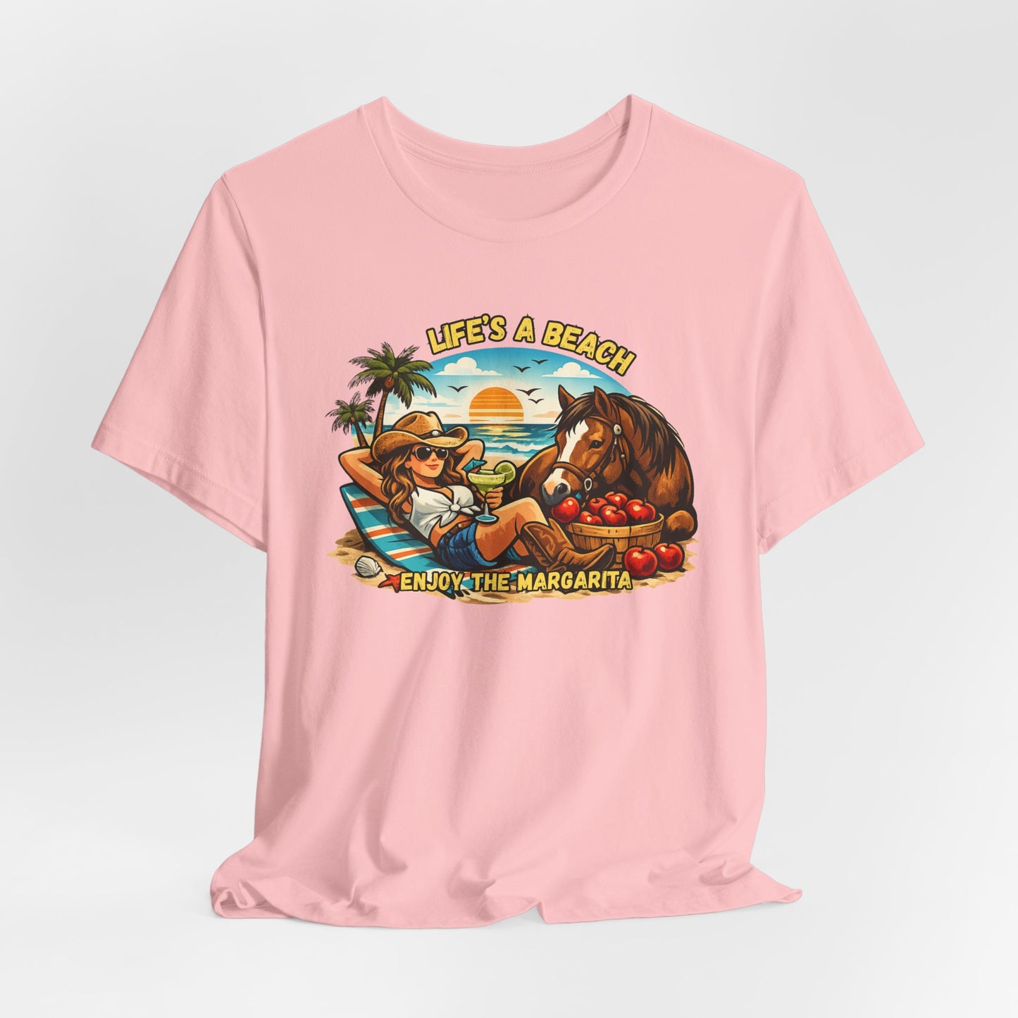 Life's A Beach Western Tee featuring a cowgirl relaxing with a horse and sunset background for stylish beach vibes.