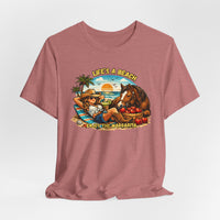Life's A Beach Western Tee featuring a cowgirl relaxing with a horse, sun, and tropical elements, promoting beach vibes and humor.