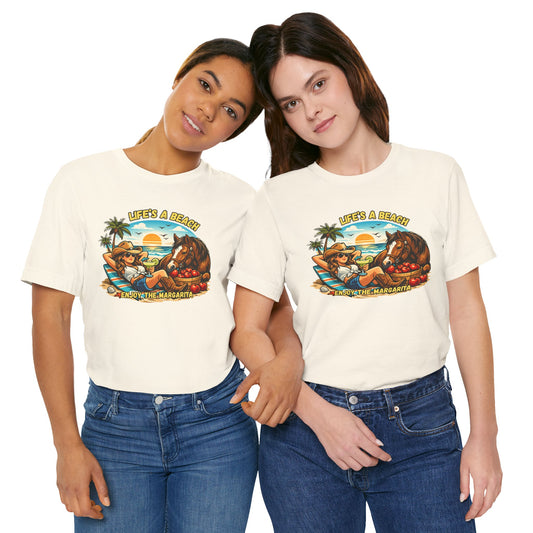Two women wearing Life's A Beach Western Tee featuring a sunset and cowboy theme, showcasing cowgirl apparel.