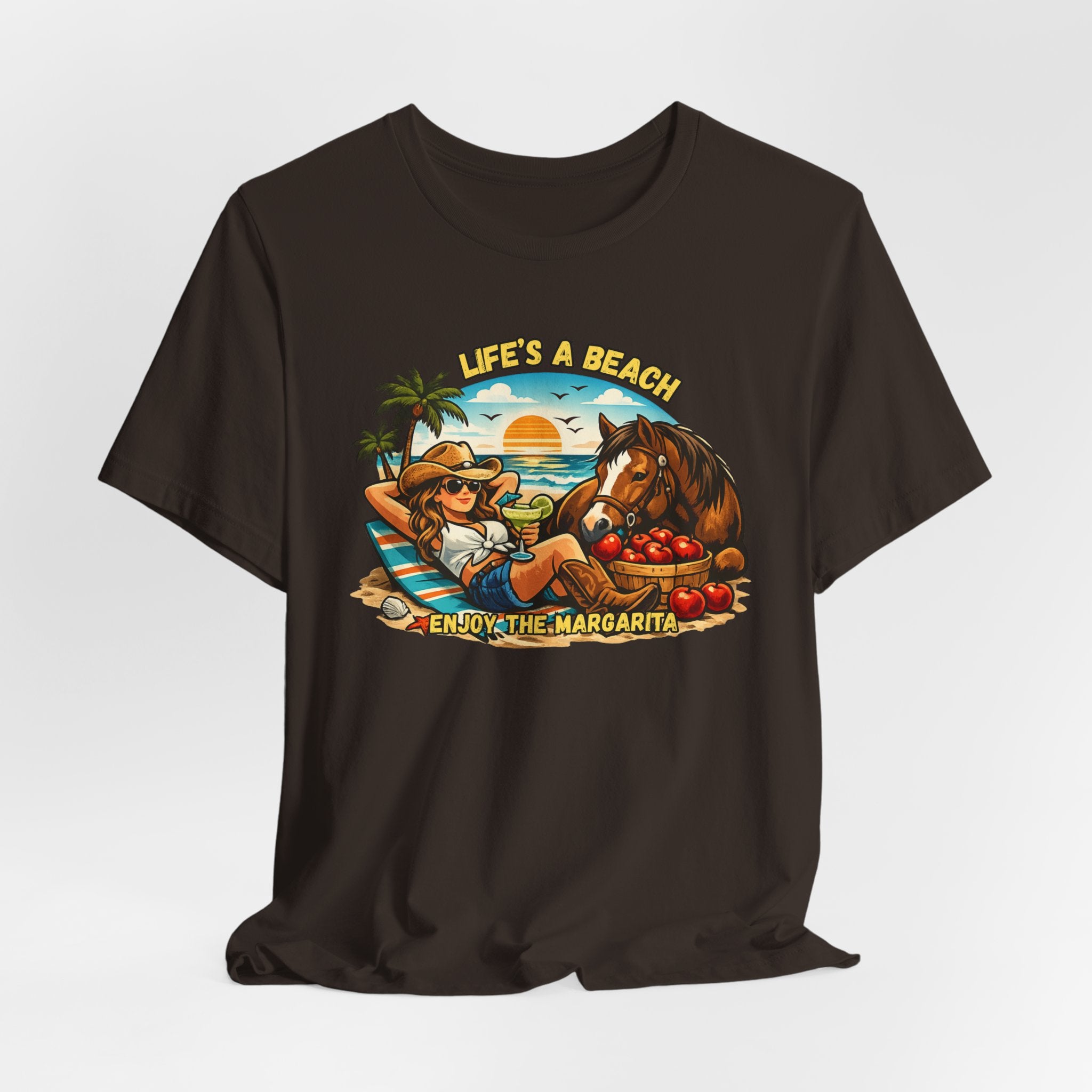 Life's A Beach Western Tee featuring a cowgirl relaxing with a horse and drinks, capturing beach vibes and humor.