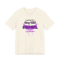 Cowgirl Western Tee featuring 'Stay Wild COWGIRL' graphic design in purple on a cream-colored t-shirt.