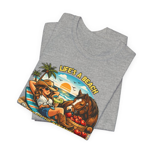 Life's A Beach Western Tee featuring a cowgirl enjoying a beach scene with a horse and sunset design.