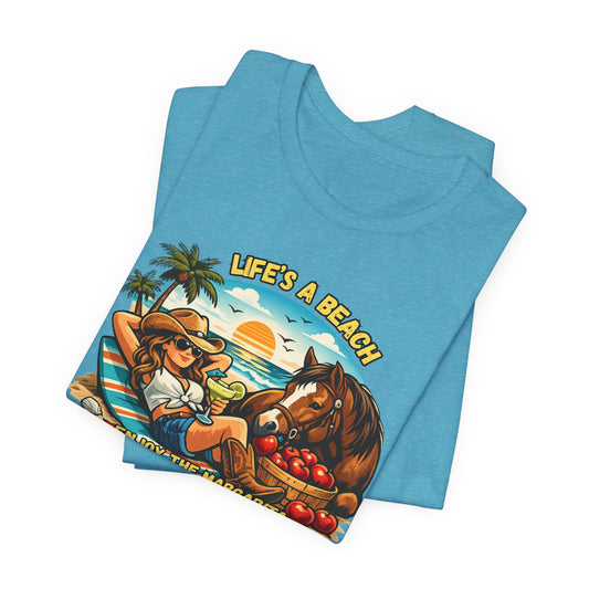 Life's A Beach Western Tee featuring a cowgirl, horse, and sunset design on a blue cotton shirt.