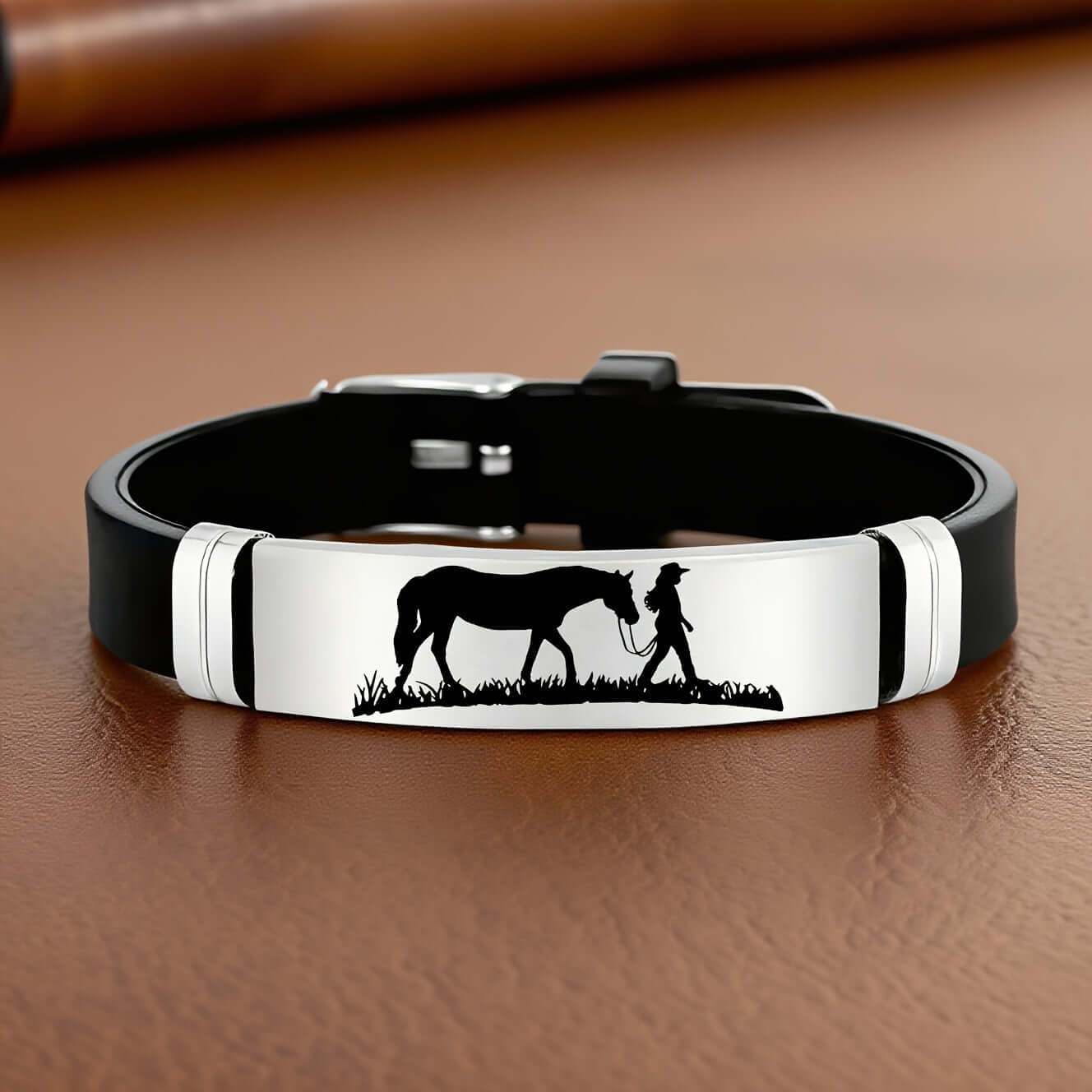 Cowgirl Bracelet featuring a silhouette of a cowgirl walking with her horse on a stainless steel and silicone wristband.