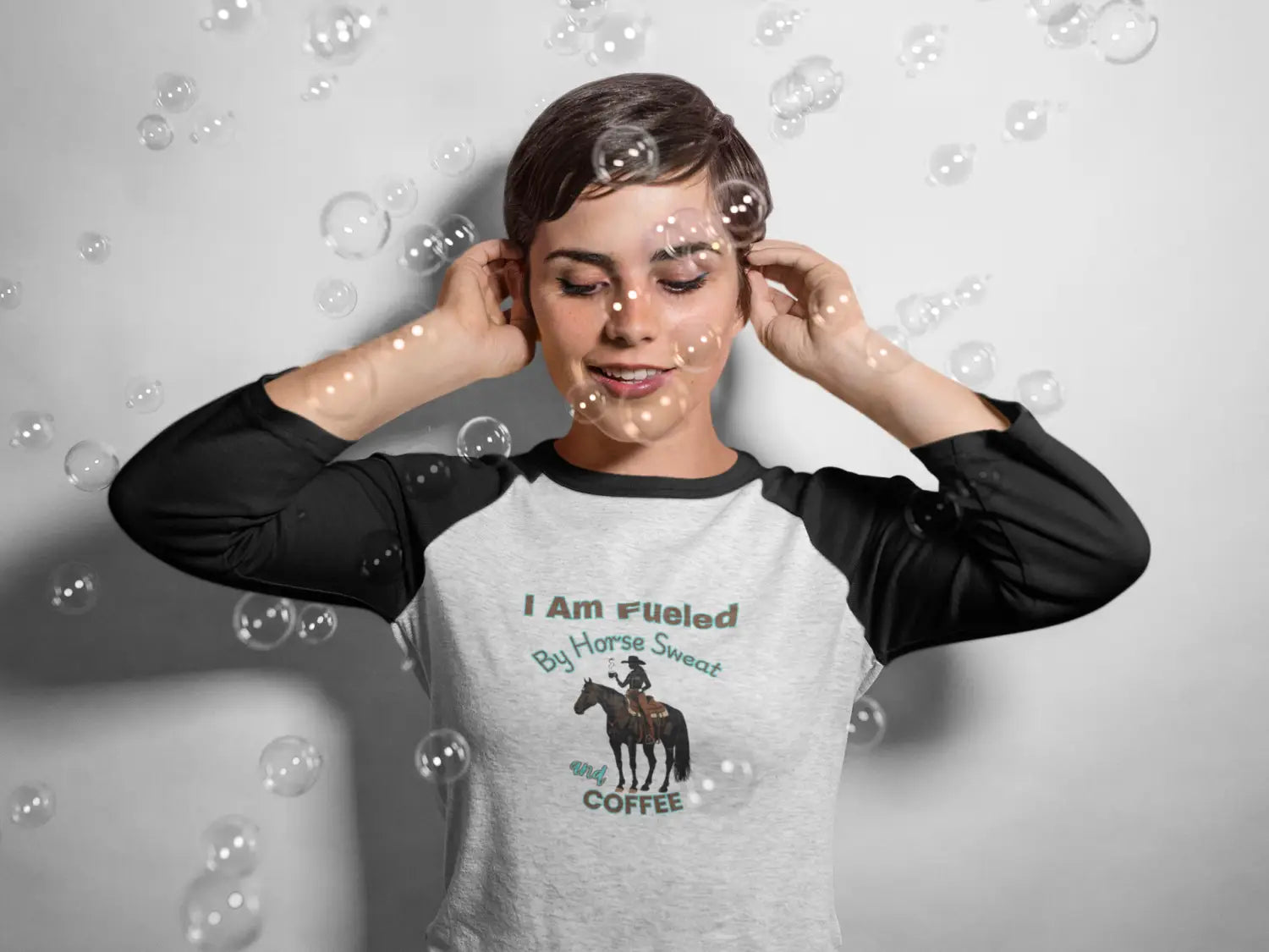 Woman wearing horse and coffee lover’s 3/4 sleeve baseball tee featuring I Am Fueled By Horse Sweat and Coffee motto